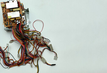 Disassembled power supply of a stationary personal computer on an isolated background. Electronics repair. Free space for inserting text.