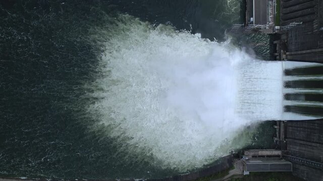 water discharge stream waterfall at the hydroelectric dam. an overflowing reservoir, a huge jet of water, aerial , a drone, the Yenisei river siberia Krasnoyarsk