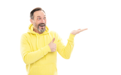 man with beard and moustache in hoody presenting product on copy space isolated on white, thumb up.