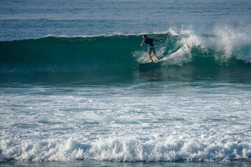 Surfer on perfect blue aquamarine wave, empty line up, perfect for surfing, clean water, Indian...