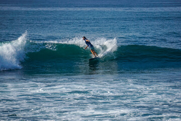 Obraz premium Surfer on perfect blue aquamarine wave, empty line up, perfect for surfing, clean water, Indian Ocean close to Mirissa