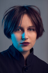 The woman in oversize black tunic dress shot in studio