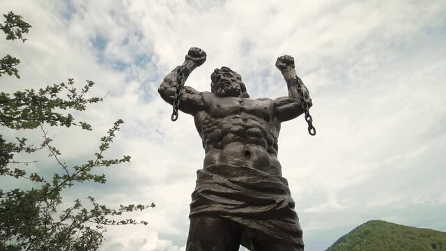 A huge sculpture of Prometheus on a rock filmed in motion on a stabilizer 