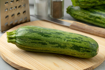  Fresh green spotted courgette on a cuttingboard close up