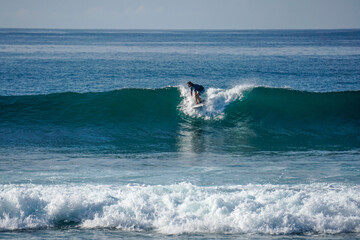 Surfer on perfect blue aquamarine wave, empty line up, perfect for surfing, clean water, Indian Ocean close to Mirissa