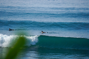 Two surfers on empty line up in the ocean close to Mirissa