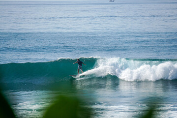 Surfer on perfect blue aquamarine wave, empty line up, perfect for surfing, clean water, Indian Ocean close to Mirissa