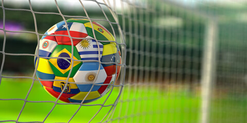 Soccer Football ball with flags of south america countries in net on football stadium. America championship 2021.