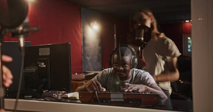 Sound engineer working in recording studio with singer