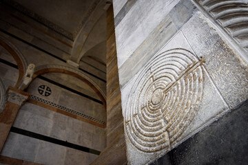 Cathedral of Lucca (Tuscany, Italy). Detail of the ancient famous maze column on the facade,...