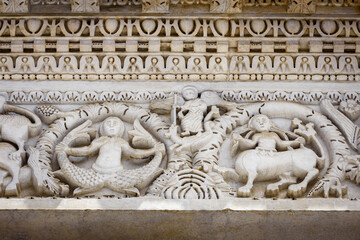 Lucca (Tuscany, Italy), church of San Michele. Details of the columns and arches of the medieval facade, with inlays and sculpture of sirens, monsters, dragons and animals