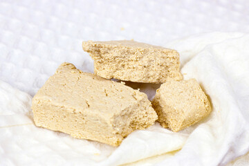 Traditional sweet turkish delight halva pieces on light background.