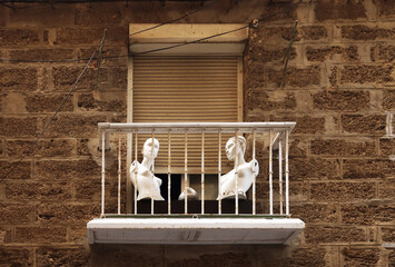 traditional poor balcony decorated with showcase dolls creating art, Cadiz, Spain