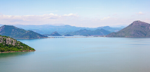 Naklejka premium Montenegro, National Park Lake Skadar. Beautiful landscape with lake Skadar and mountains on sunny spring day