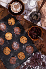 Cookies with chocolate and coffee on a wooden table, flat lay, top view