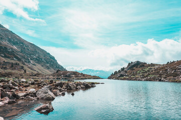 Lake landscape between mountains with blue sky in the background.