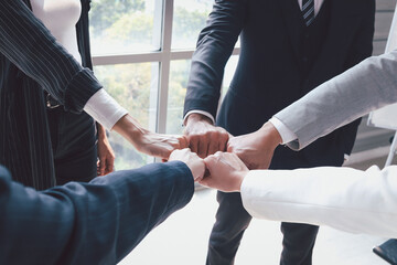 businessman and woman putting hands fist join together, business partnership colleagues holding hands as commitment of strong team work, unity and teamwork join hands support concept