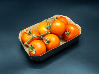 tomatoes in a box, on a black background