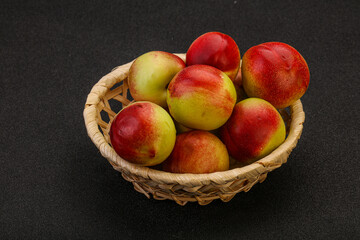 Sweet small nectarines in the basket