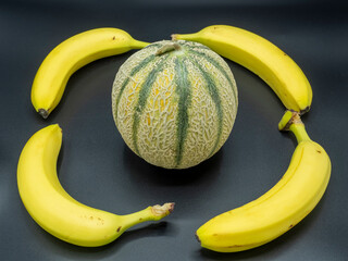 4 bananas and a green melon