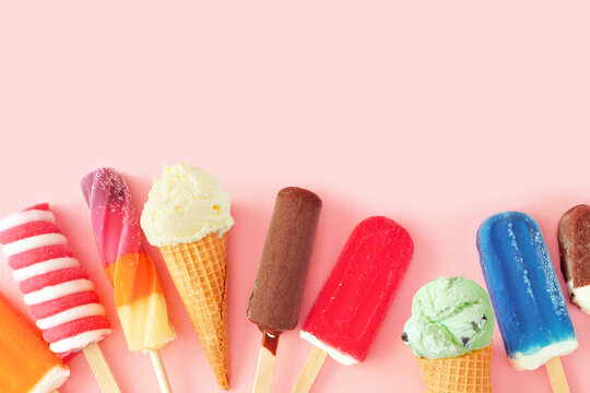 Collection Of Colorful Summer Frozen Desserts. Top View Bottom Border On A Pink Background. Copy Space.