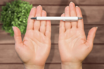 Classic mock up pen in woman hands. Design under table background