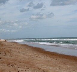 The sand and the ocean on a sunny summer day.