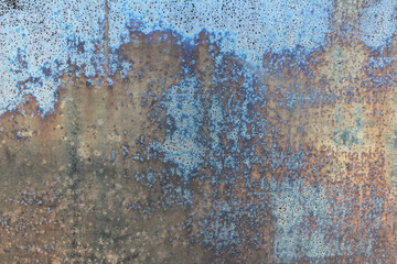 Metal old rusty defective wall with blue peeling paint for background