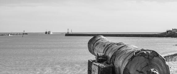 Vendée, FRANCE; May 27, 2021: Black and white photo of the cannon of the entrance to the port of Saint Gilles Croix de Vie, English cannon from 1747 sunk on the island of Noirmoutier. 