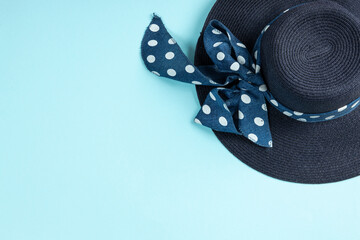 Blue hat with ribbon on blue background. Summer concept. Top view with copy space