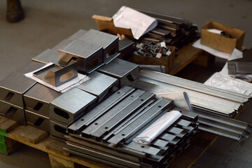Final stage CNC material. Metal products after processing on CNC machines stand on pallets ready...