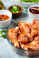 Marinating Raw Chicken Drumsticks in Herbs and Spices