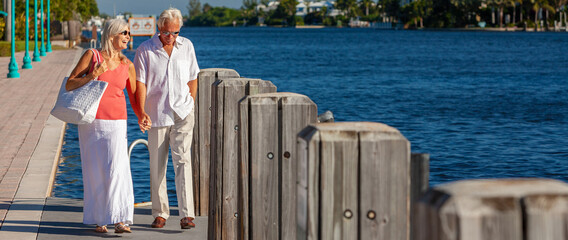Happy Senior Couple Walking By The Sea in Tropical Resort Panorama - 439015386