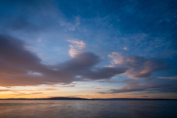 Naklejka na ściany i meble Cloudscape above Helgøya Island in Lake Mjøsa at evening.