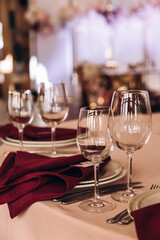 Champagne glasses. Candles and flowers. Banquet table decoration.