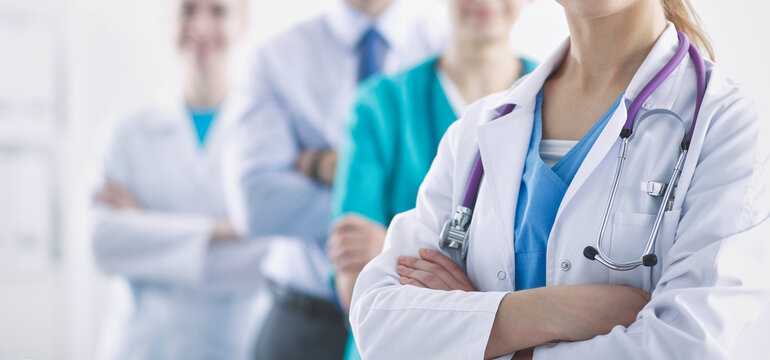 Attractive female doctor in front of medical group