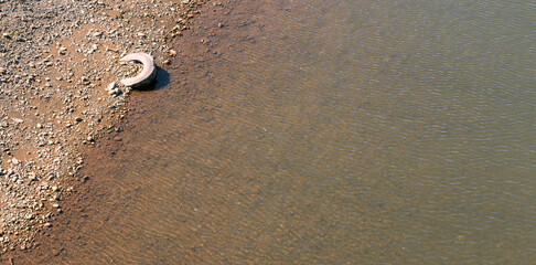 Tire on the river bank