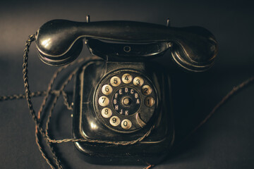 vintage black old rotary telephone handset on black background