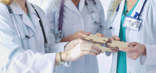 Doctors and nurses in a medical team stacking hands