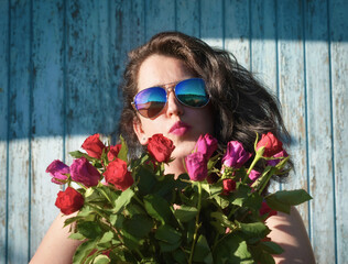 Portrait of a woman in sunglasses with roses