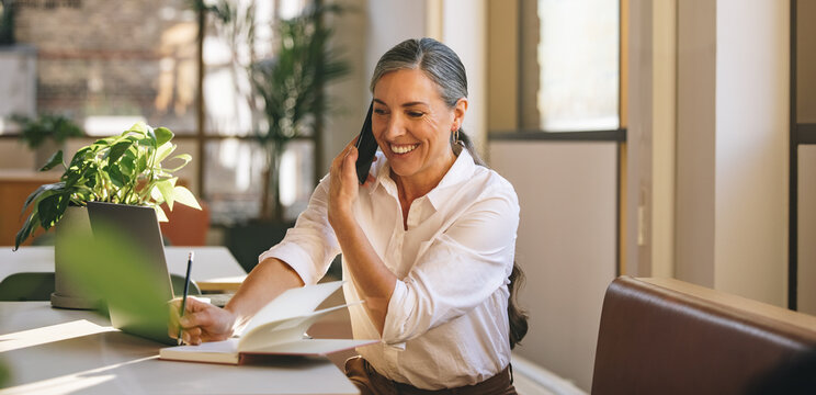 Businesswoman Noting Down Clients Requirements