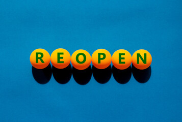 Reopen and bonus symbol. The concept word 'reopen' on orange table tennis balls on a beautiful blue...