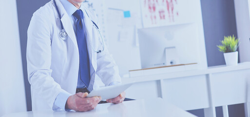 Portrait of a smiling doctor in his bright office