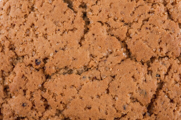 Texture background of oat cookie with sugar and raisins.