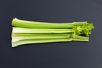 Fresh celery on dark background.