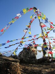 Colorful Prayer Flags on the Mountain Peak Against Blue Sky Langtang National Park Nepal