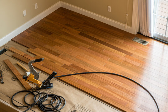 Morgantown, WV - 7 June 2021: Bostitch Nailing Gun Ready To Install Brazilian Cherry Tropical Hardwood Flooring