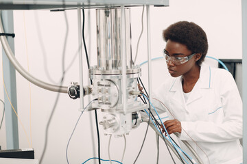 Scientist african american woman working in laboratory with electronic tech single photon detector....