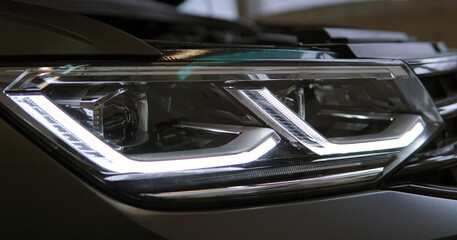 Headlight of a modern car close up. Modern technology concept. Selected focus.	