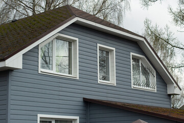 Country house outside the city. Residential building windows.